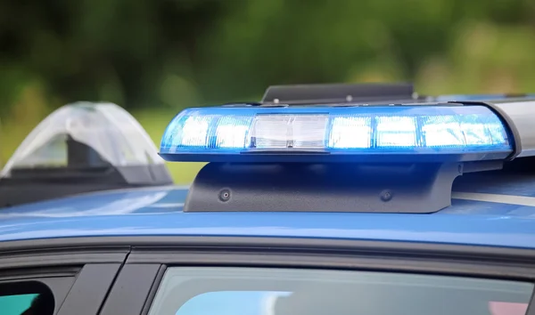 Piscar azul do carro de polícia durante uma perseguição entre carros — Fotografia de Stock