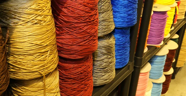 Estante lleno de madejas de hilos de colores de lana y algodón para s — Foto de Stock