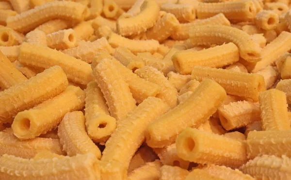 Macaroni yellow dry pasta in the shape of small tubes — Stock Photo, Image