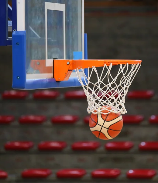 Basketball in the basket during the game in the sports hall — Stock Photo, Image