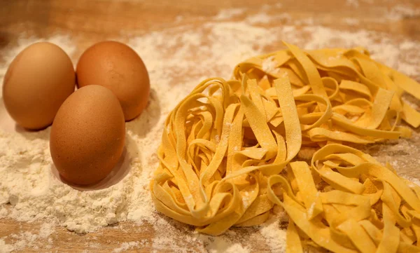 Macro photograph of three eggs with flour and fresh homemade ita — Stock Photo, Image