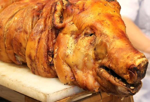 Roast pork with the big nose in the rotisserie — Stock Photo, Image