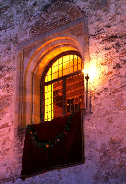 Window of an ancient castle with torches