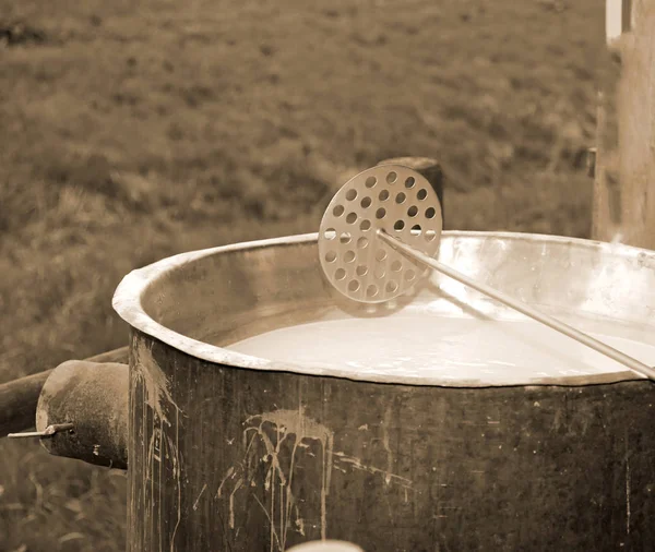 Special tool to mix the rennet milk in the copper cauldron — Stock Photo, Image