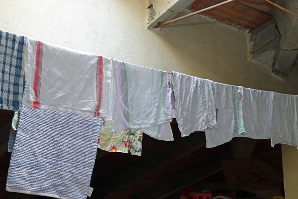 Clothes hanging in the attic — Stock Photo, Image