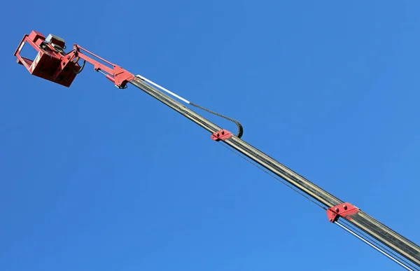 Metal basket of an aerial platform with mechanical arm extended — Stock Photo, Image