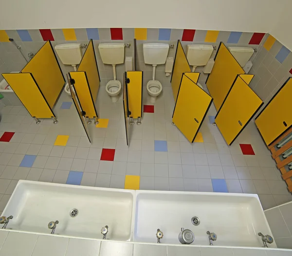 Inside a bathroom of a nursery school with small toilets — Stock Photo, Image