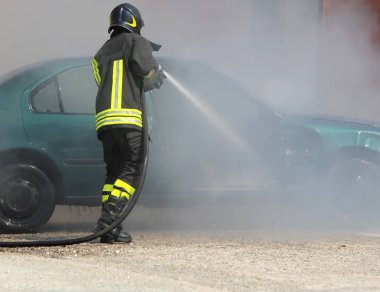 itfaiyeci bir araba yangın söndürür