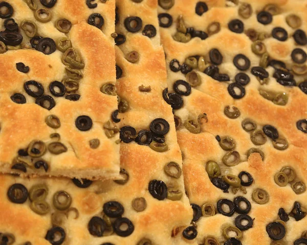 Focaccia bread with a lot of slices of olives from the Italian T — Stock Photo, Image