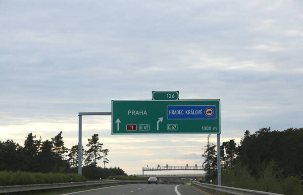 Highway sign with directions to reach the city of Prague i