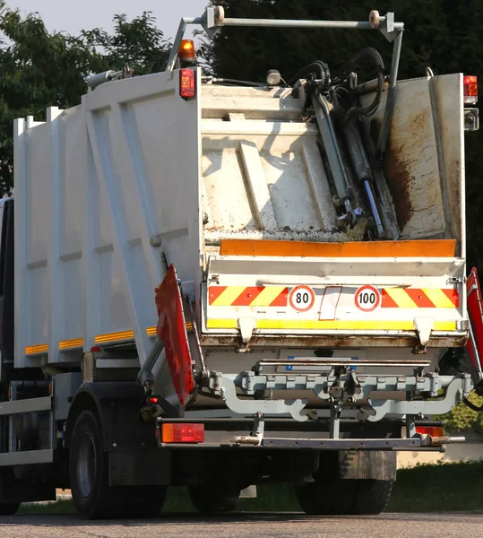 Waste collection vehicle operating in the streets