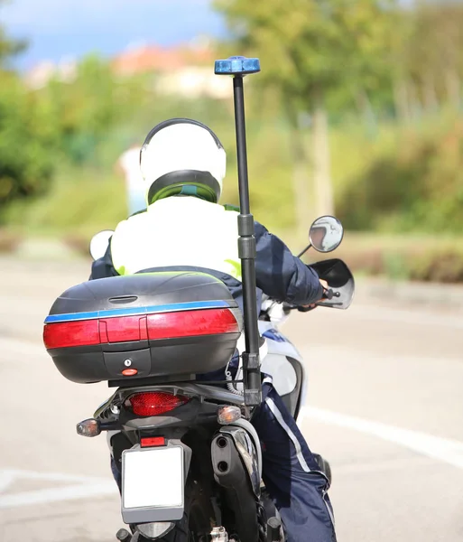 Policeman with helmet on the police motorcycle while patrolling — Stock Photo, Image