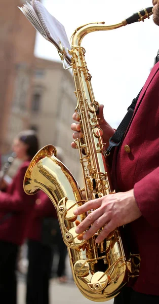 Hand of player and the golden saxophone — Stock Photo, Image