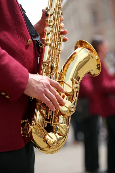Hand of player and the saxophone in the main square — Stock Photo, Image