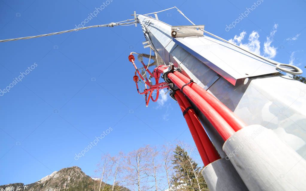 iron pole of an electrical system with cables and high voltage i