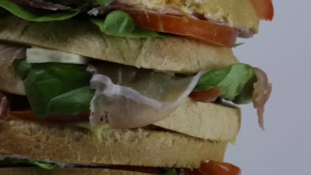 Sandwich stuffed with layers of bread with lettuce tomato cheese — Stock Video