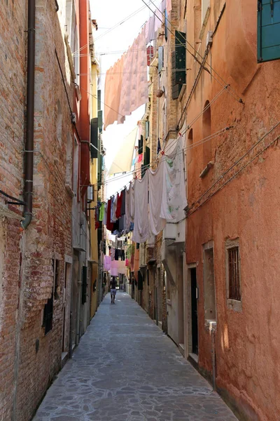 ヴェネツィアの狭い通りにぶら下がっている非常に多くの服と呼ばれる — ストック写真