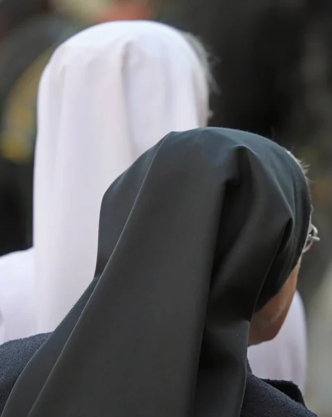 Sisters with black and white veil during the holy mass — Stock Photo, Image