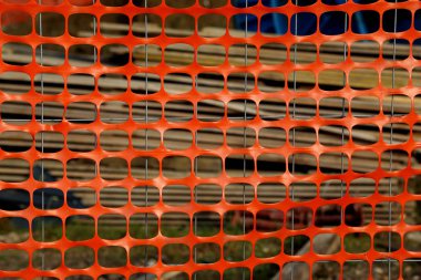 orange plastic protective net for delimiting the area of a dange clipart
