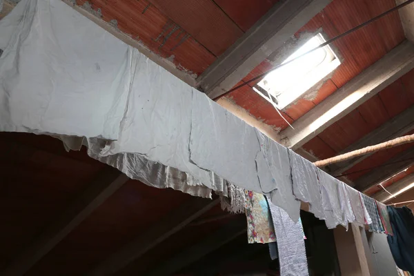 Attic with a skylight and cloths hung to dry — Stock Photo, Image