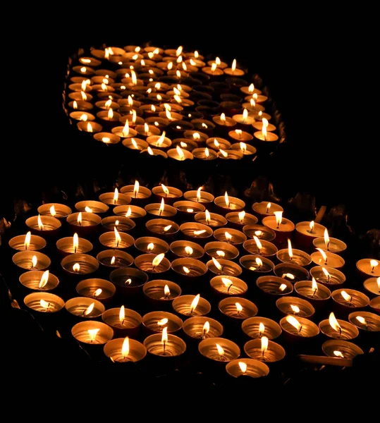 Свечи зажжены теплым пламенем во время религиозной церемонии — стоковое фото