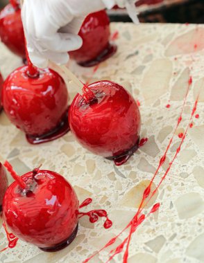 karamelize şeker şurubu ve ahşap sopa ile kırmızı elma