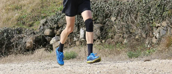 runner during training with the sports apparel and a knee brace