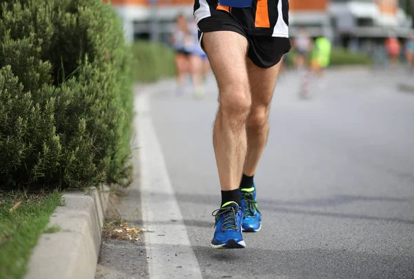 Athlete running during the marathon — Stock Photo, Image