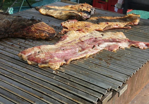 Meat in a food stall on the street with bacon and cooked pork — Stock Photo, Image