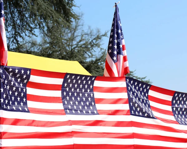 Serie de muchas banderas americanas con cielo azul al aire libre — Foto de Stock