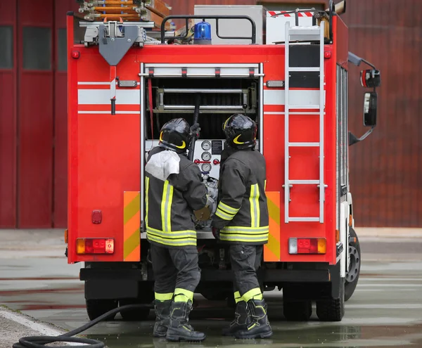 Пожежники і пожежна машина під час місії — стокове фото