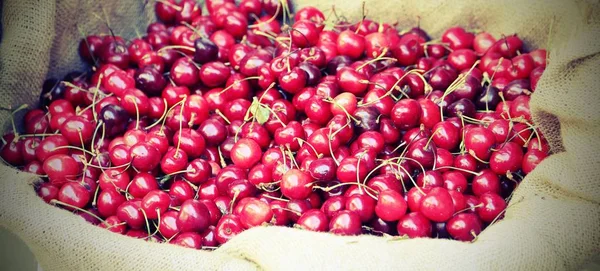 Basket of red cherries with vintage effect — Stock Photo, Image