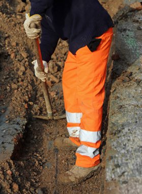 adam bir roa üzerinde çalışırken yüksek görünürlük giyim ile iş yerinde