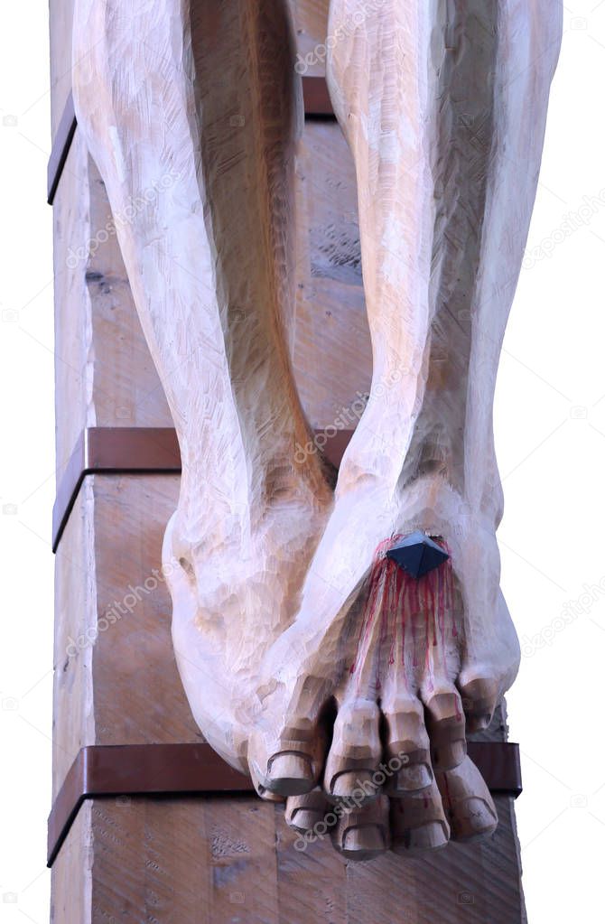 wooden feet with blood of a statue