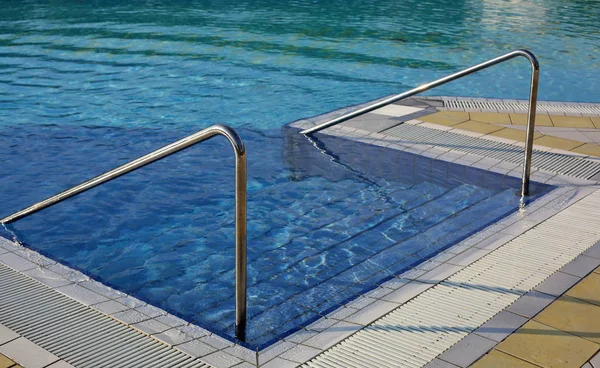 Steel handrail to access the pool for muscle rehabilitation at a — Stock Photo, Image