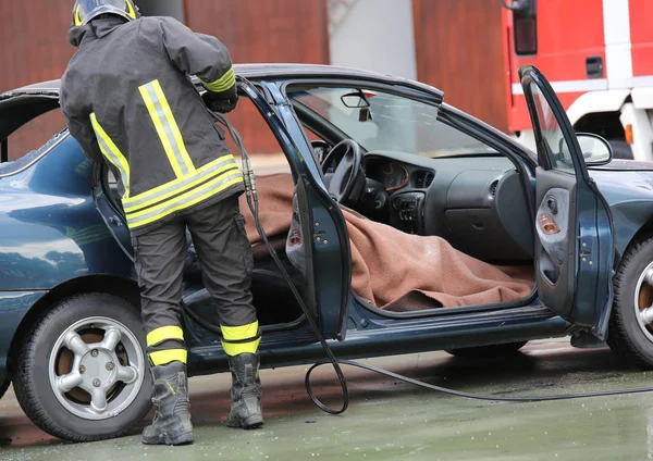 Firefighter team pulls the man wounded by the car after a road a Royalty Free Stock Images