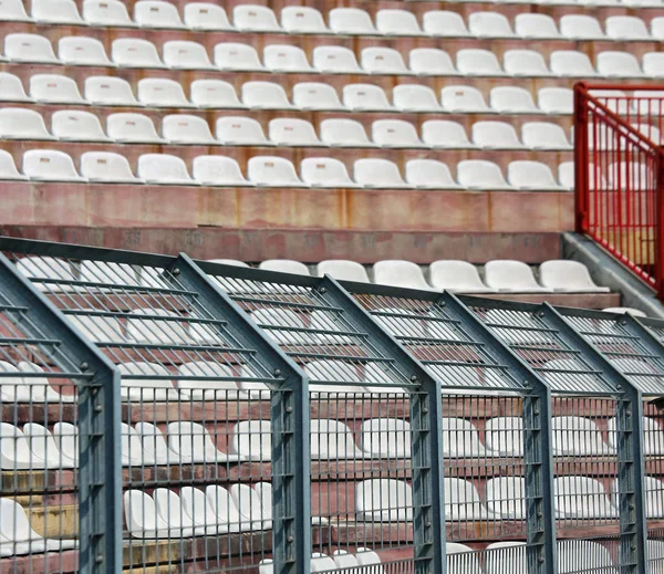 Metal fence in the stadium to divide the fans on the pitches fro — Stock Photo, Image