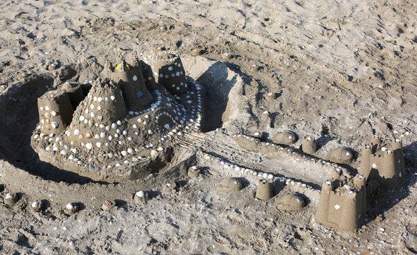 sand castle on the beach by the sea in summer