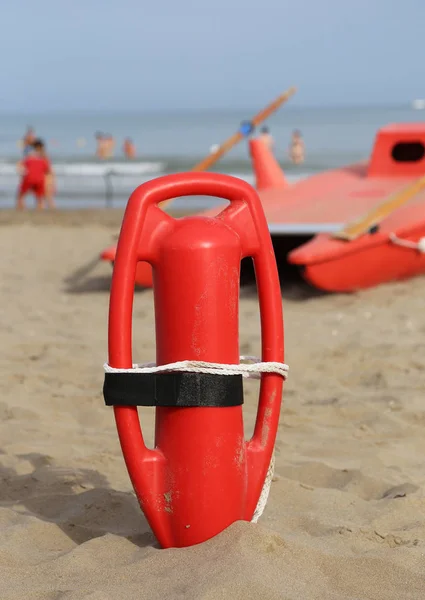 Lifebuoy lift and lifeboat on the beach — стоковое фото