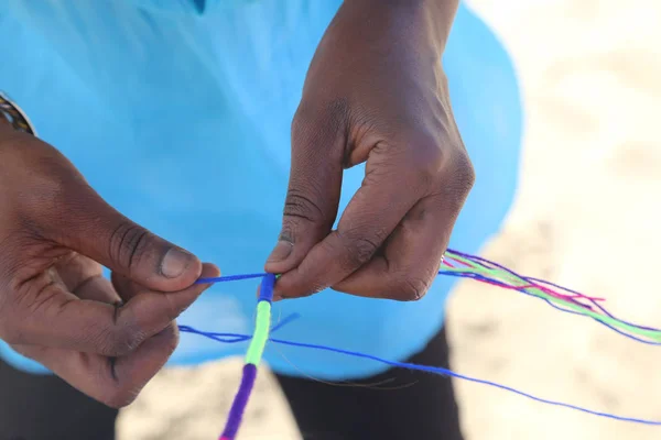 Mujer africana hace un peinado con una trenza de colores en el hai —  Fotos de Stock