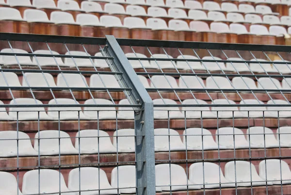 Metal fence in the stadium to divide the fans on the pitches fro — Stock Photo, Image