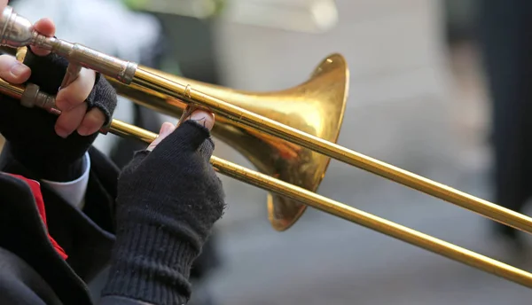 Hand of elderly man with gloves playing the trumpet — Stock Photo, Image