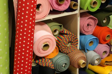 fabrics of many varieties in the textiles and fabrics shop clipart