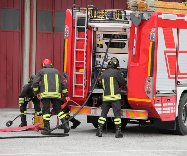 Firefighters and the fire truck during a pericles mission — Stock Photo, Image