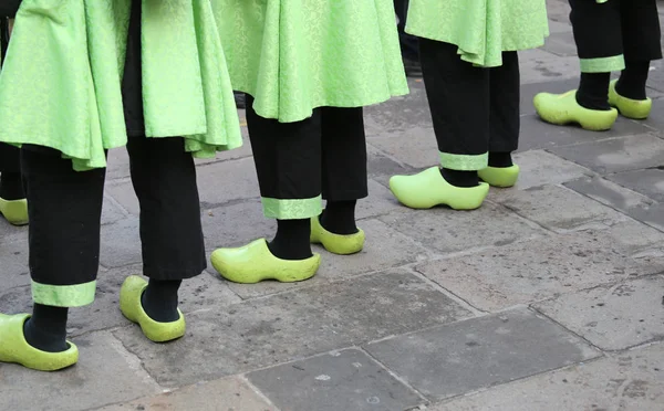 Dutch people with green clogs and black trousers