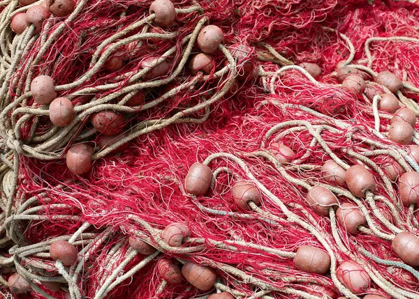 Background of red fishing nets with floats used to fish Stock Image