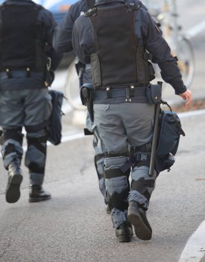 police patrol in riot police with gun and pistol during revolt clipart