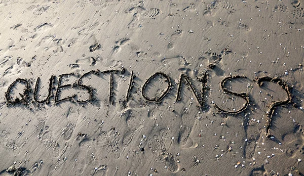 Text QUESTIONS with question mark written on the sand can be use