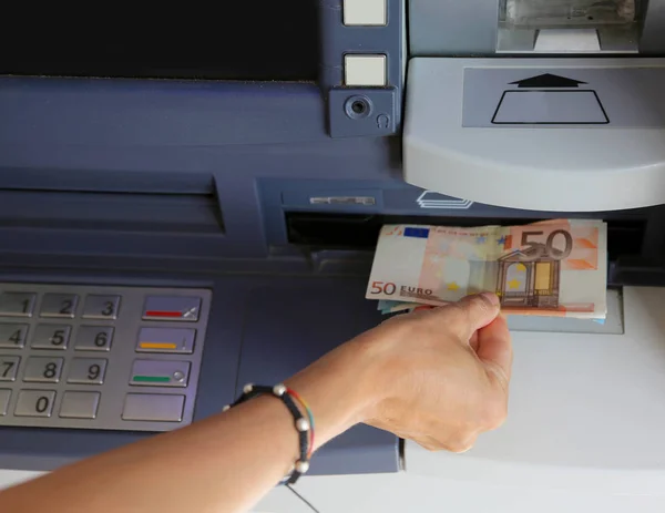Woman takes money from the ATM in Europe — Stock Photo, Image