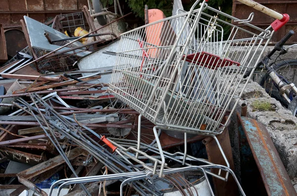 Shopping cart in the landfill of ferrous material — Stock Photo, Image